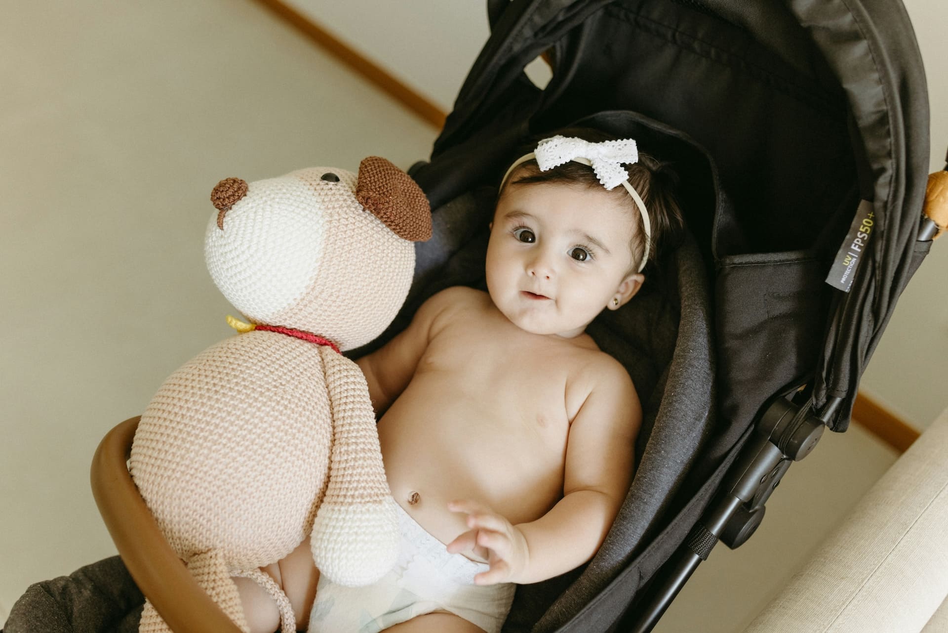 baby stroller Baby Brightness baby stroller: A comfortable grey stroller with a cute baby, showcasing quality and safety for NZ families.
